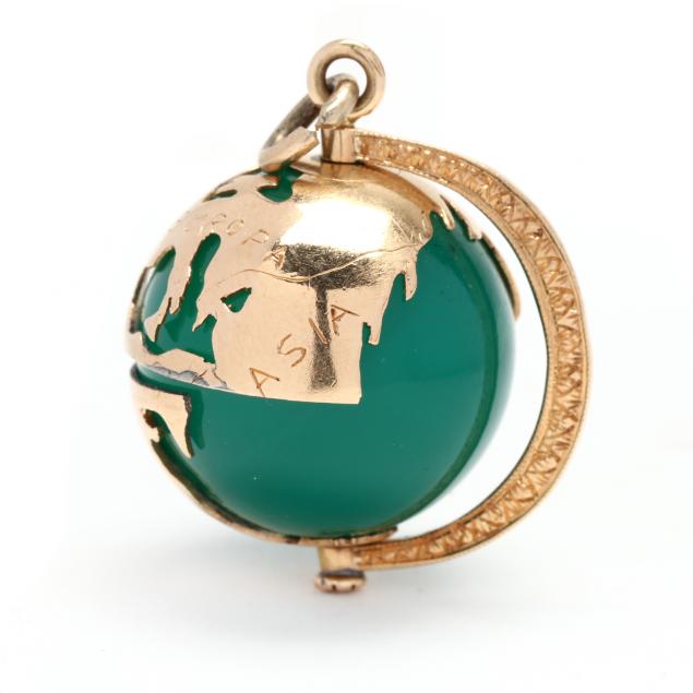 Appraisal: GOLD AND CHALCEDONY GLOBE CHARM The round dyed green chalcedony