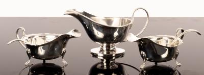 Appraisal: A pair of silver sauce boats Viners Sheffield another sauce