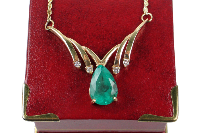 Appraisal: EMERALD DIAMOND AND FOURTEEN KARAT GOLD PENDANT NECKLACE the V-shaped