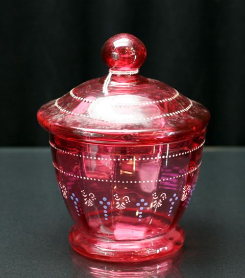 Appraisal: A Victorian cranberry glass bowl and cover with enamelled beaded