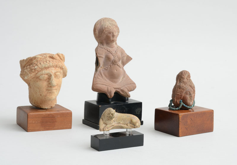 Appraisal: FOUR ANCIENT FIGURAL FRAGMENTS Comprising a carved stone head of