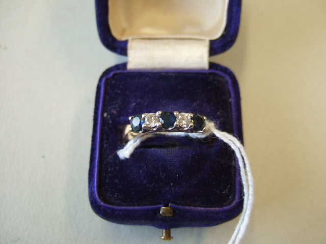 Appraisal: A sapphire and diamond fire stone ring claw set in