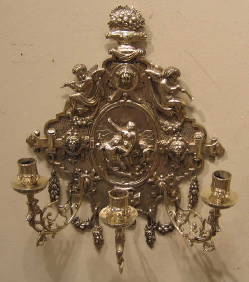 Appraisal: PAIR OF CONTINENTAL PLATED SILVER WALL SCONCES Elaborately decorated each