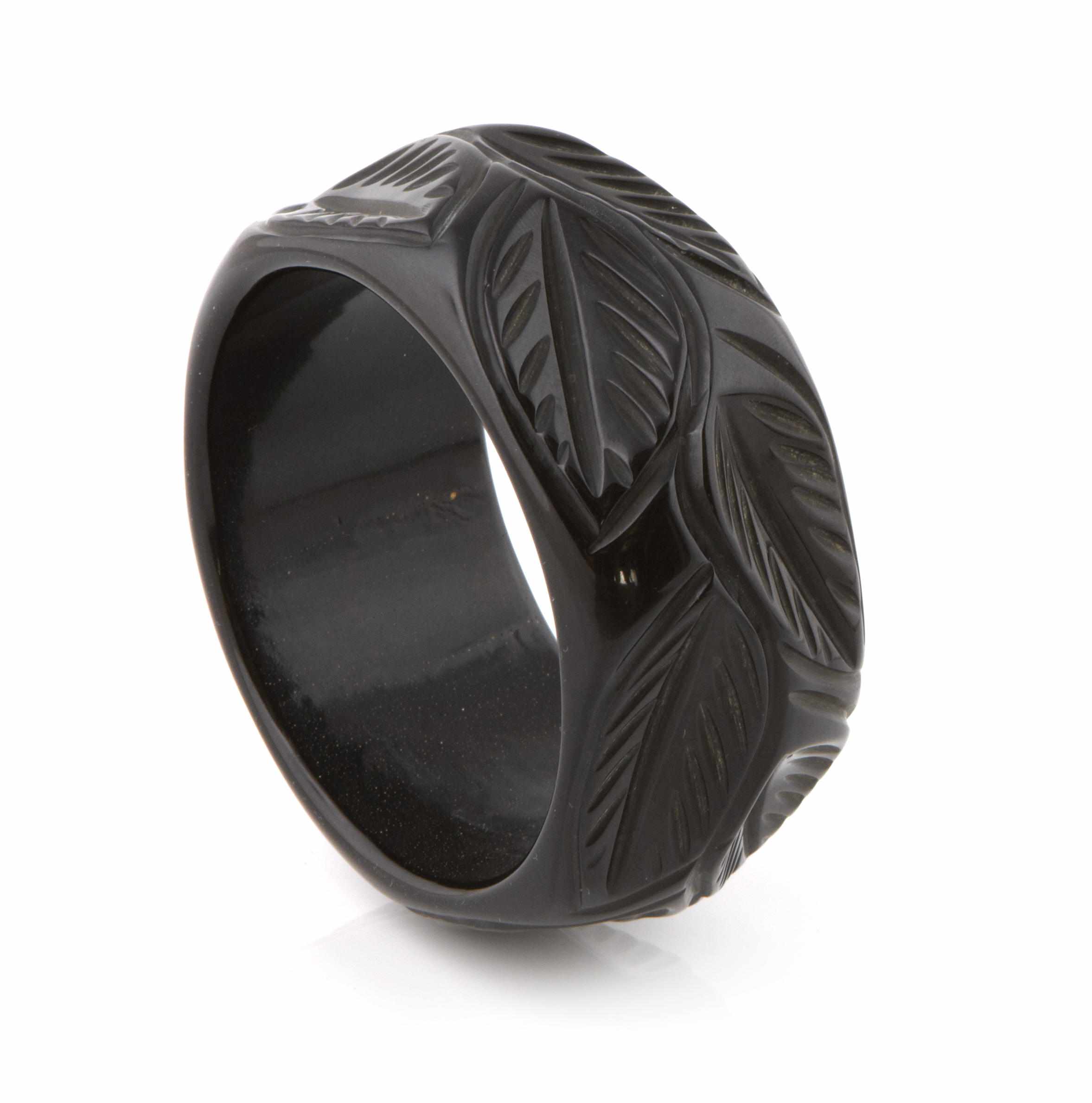 Appraisal: A deeply carved black foliate Bakelite bangle bracelet diameter in