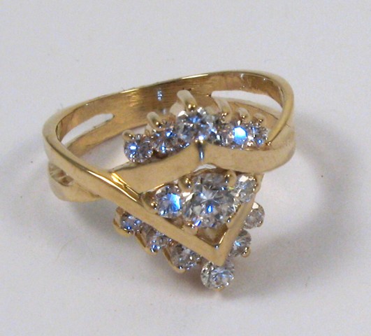 Appraisal: DIAMOND AND FOURTEEN KARAT GOLD RING set with round-cut diamonds