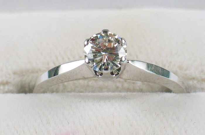 Appraisal: DIAMOND AND FOURTEEN KARAT WHITE GOLD SOLITAIRE RING WITH APPRAISAL