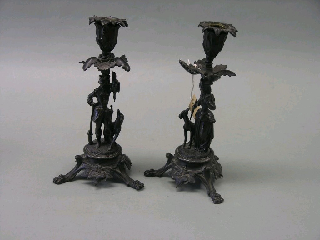 Appraisal: A pair of brass figural candlesticks one stem cast in