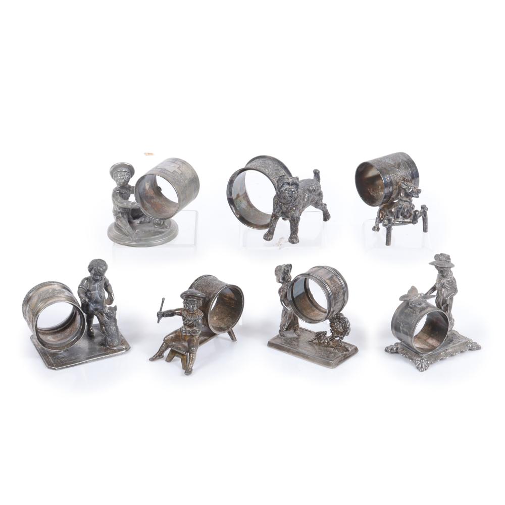 Appraisal: SEVEN VICTORIAN SILVER PLATE FIGURAL NAPKIN RINGS WITH PLAYFUL CHILDREN