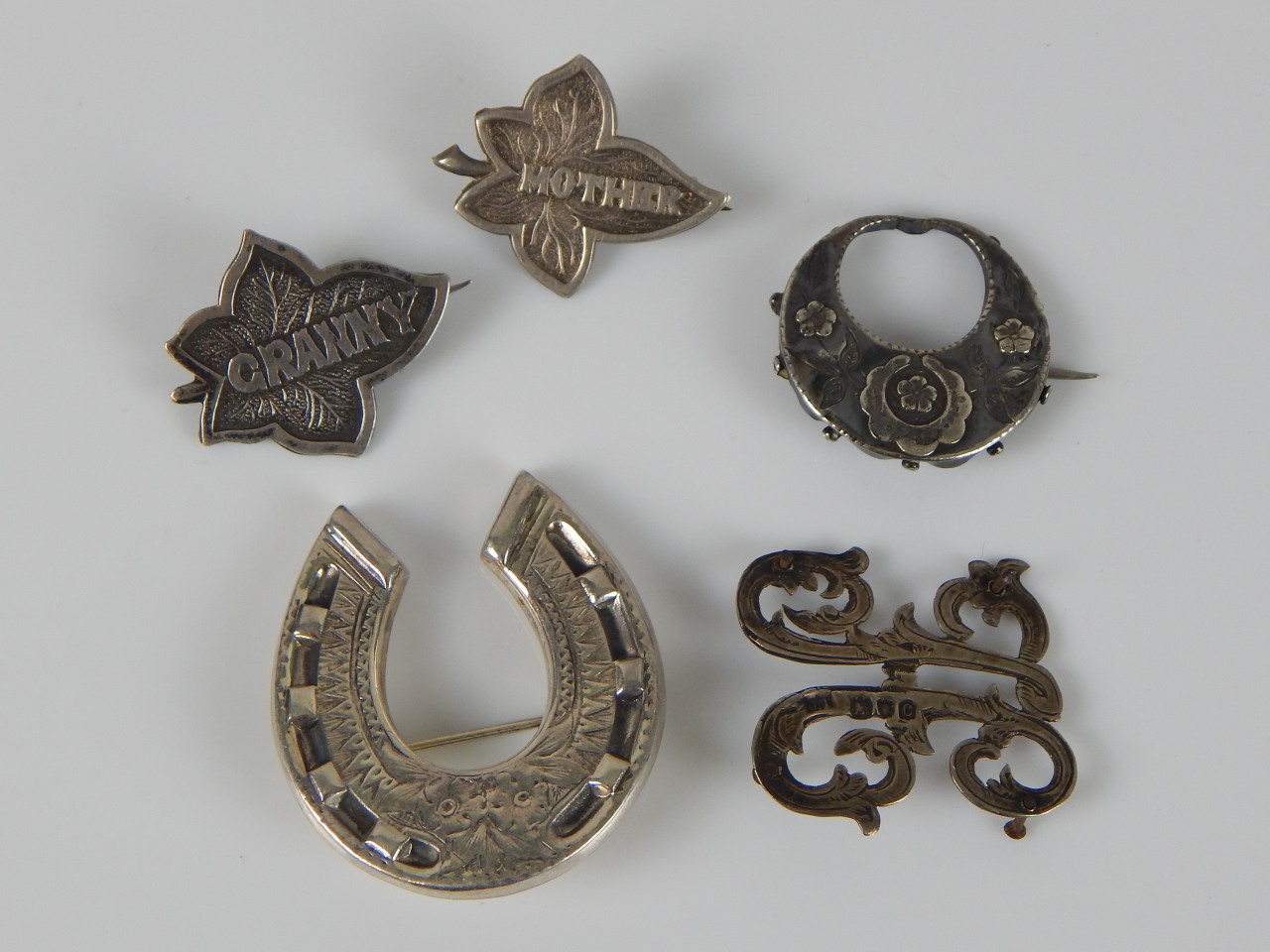 Appraisal: Five brooches to include two Victorian leaf brooches marked 'Mother'