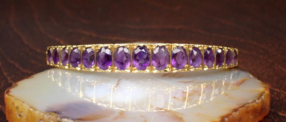 Appraisal: ITALIAN MADE AMETHYST AND EIGHTEEN KARAT GOLD BANGLE The oval