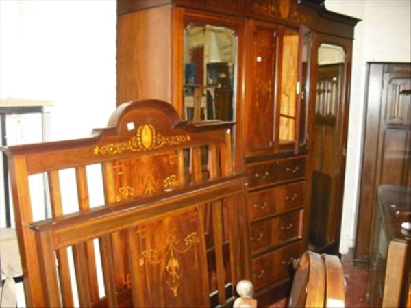 Appraisal: A Victorian inlaid bedroom suite comprising wardrobe bed ends dressing