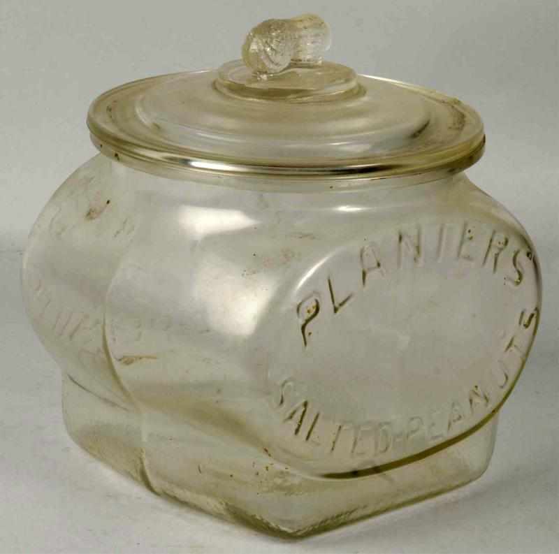 Appraisal: Embossed Planters Peanut Football Jar Lid Description Light soiling with