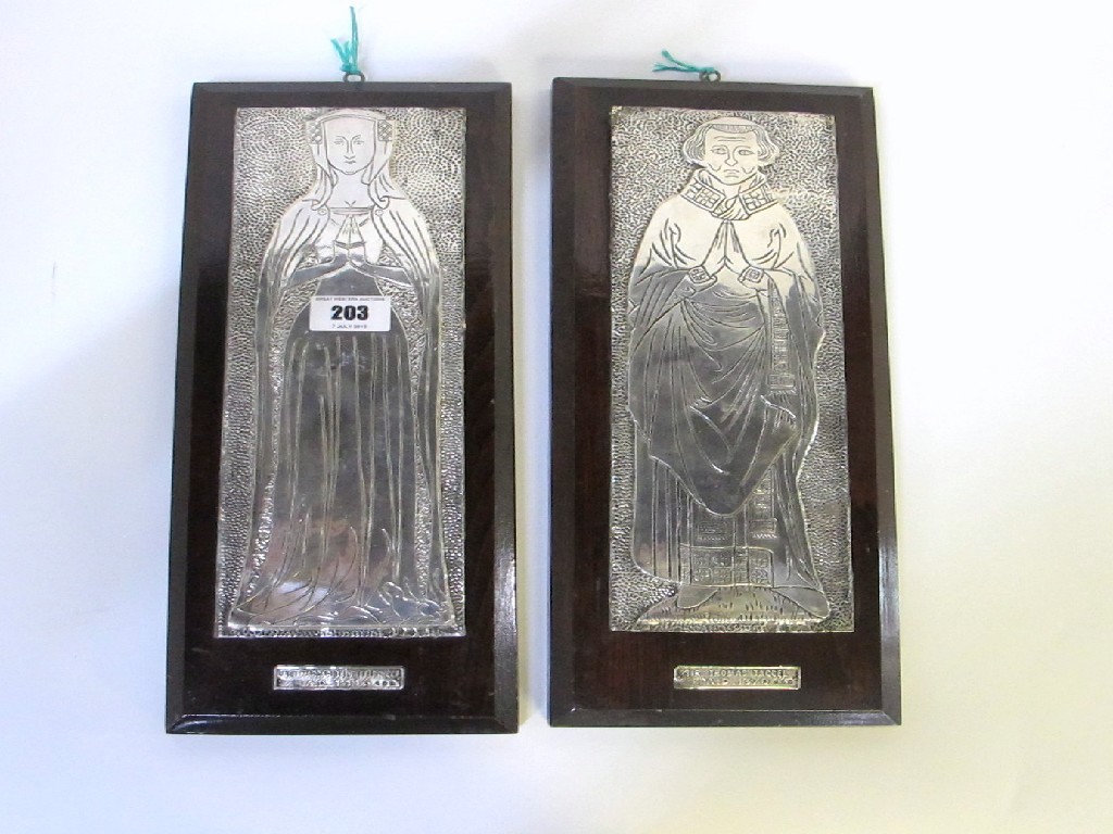 Appraisal: A pair of silver wall plaques depicting a medieval man