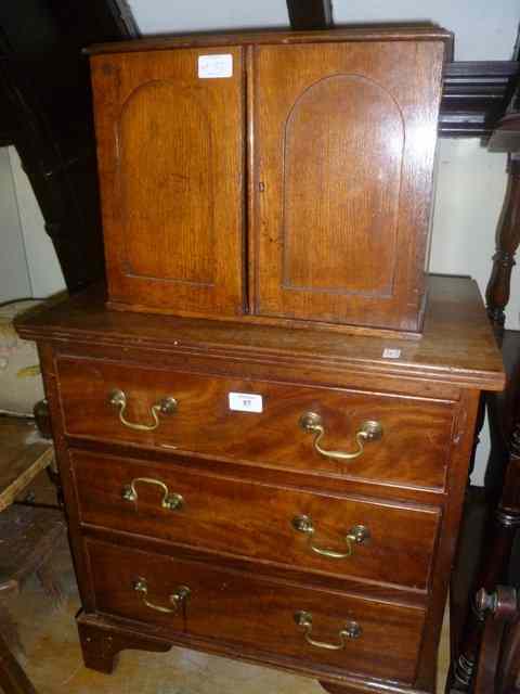 Appraisal: A SMALL GEORGIAN STYLE MAHOGANY CHEST of three long drawers