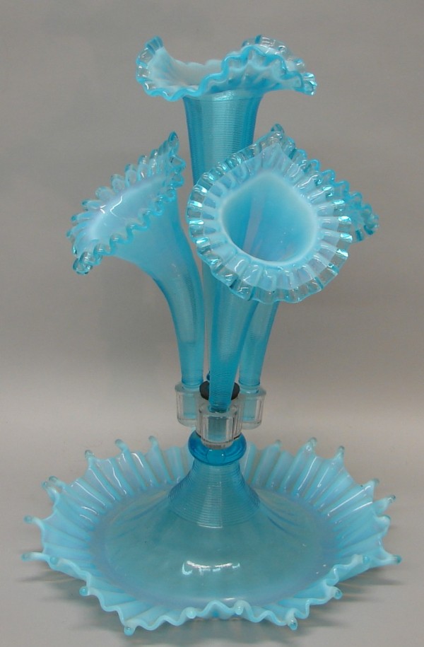 Appraisal: Northwood blue glass epergne features four flutes with wavy rims