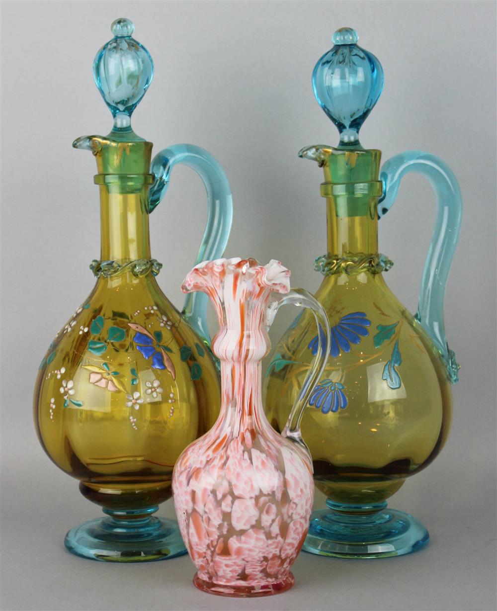 Appraisal: TWO AMBER AND BLUE GLASS CARAFES the amber bodies decorated