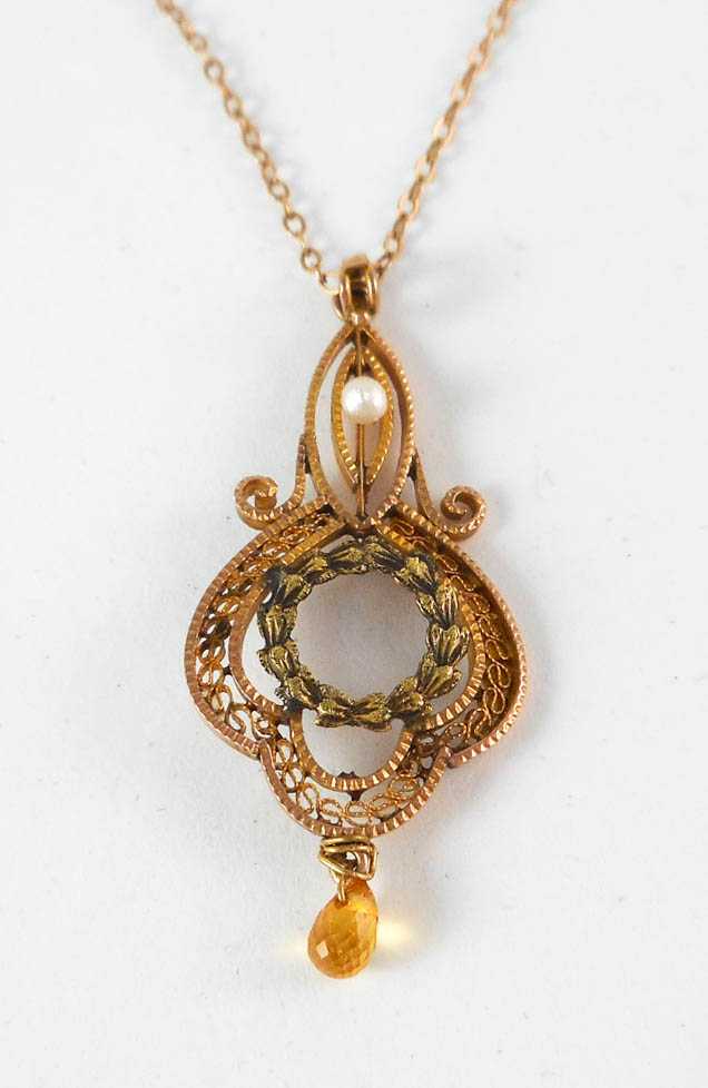 Appraisal: YELLOW SAPPHIRE AND SEED PEARL PENDANT NECKLACE suspended on a