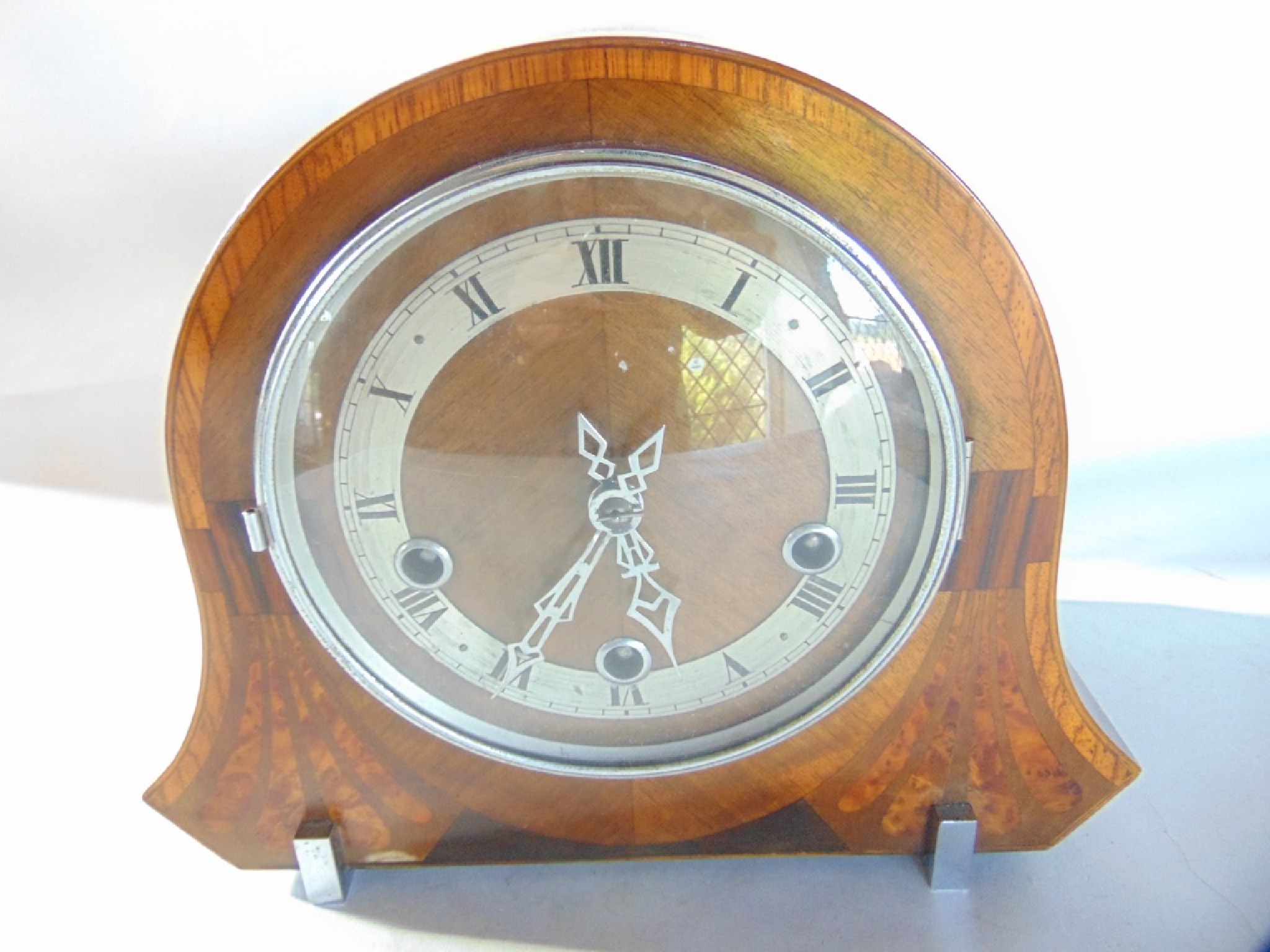 Appraisal: An Art Deco mantle clock principally in walnut but with