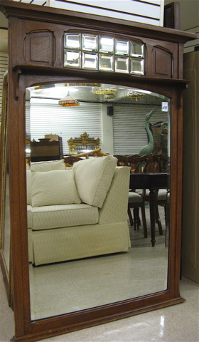 Appraisal: AN OAK AND BEVELED GLASS PIER MIRROR Continental c a