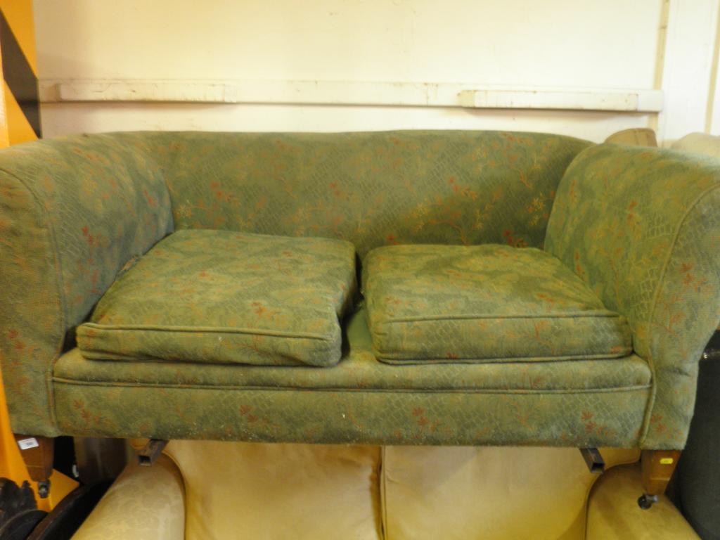 Appraisal: An Edwardian Chesterfield type sofa with drop arm on square