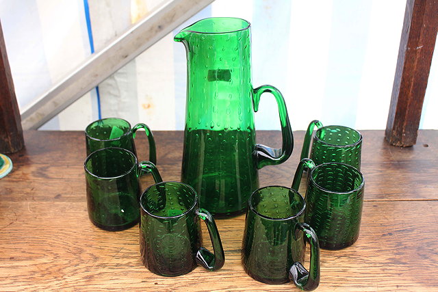 Appraisal: AN EMERALD GREEN GLASS ALE SET possibly Whitefriars with bubble