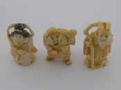 Appraisal: Three Japanese okimono figures a lady holding a sack signed