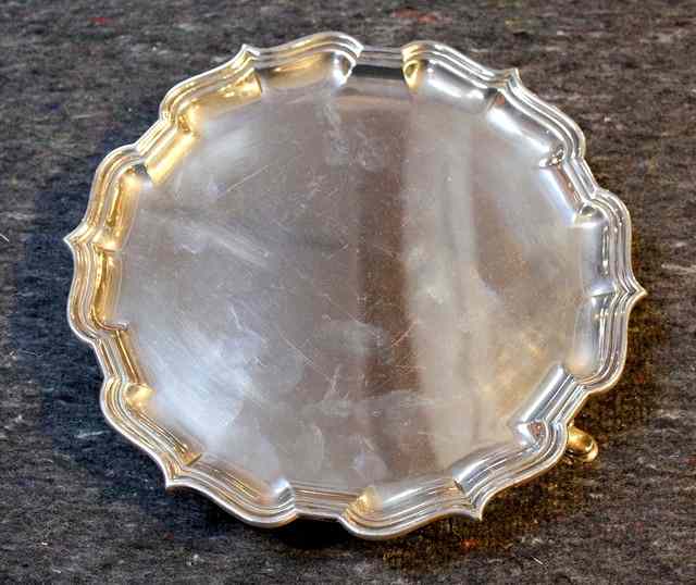 Appraisal: A SILVER SALVER with Chippendale border and three hoof feet