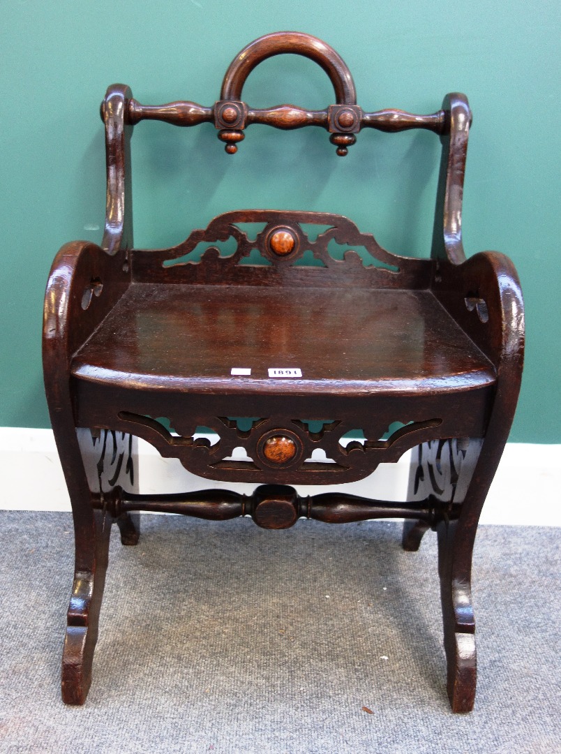 Appraisal: A small Victorian stained oak hall bench with fret pierced