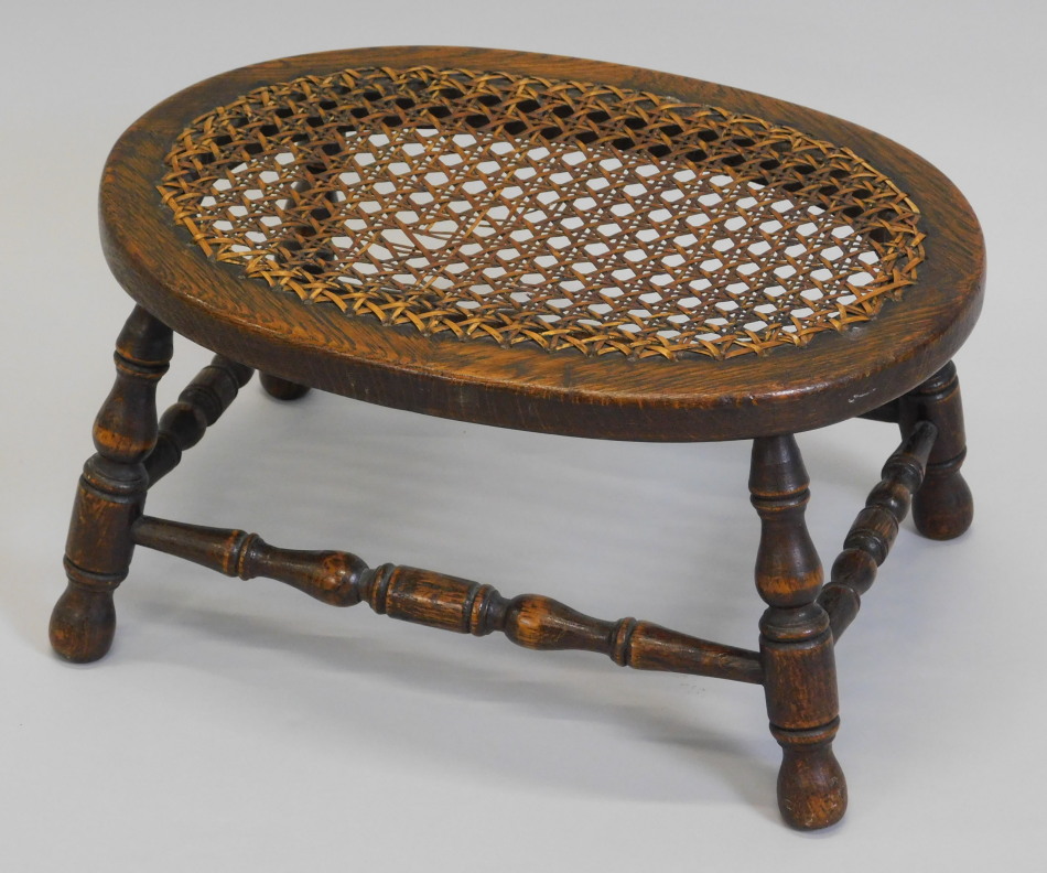 Appraisal: An oak stool the oval top with a caned insert