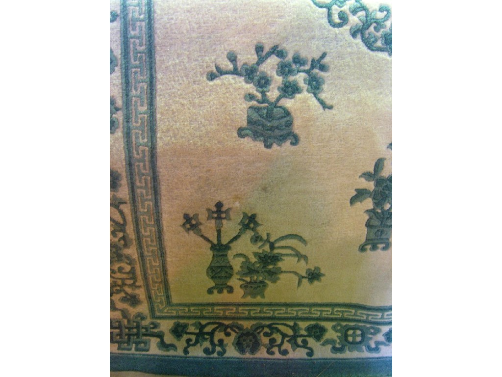 Appraisal: A cream ground Chinese wool rug with flower vase decoration