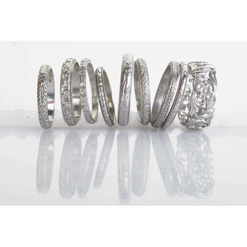 Appraisal: NINE EMBOSSED OR ENGRAVED PLATINUM BAND RINGS Condition Report