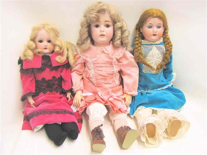 Appraisal: THREE GERMAN BISQUE SOCKET HEAD DOLLS blond ringlet wig brown