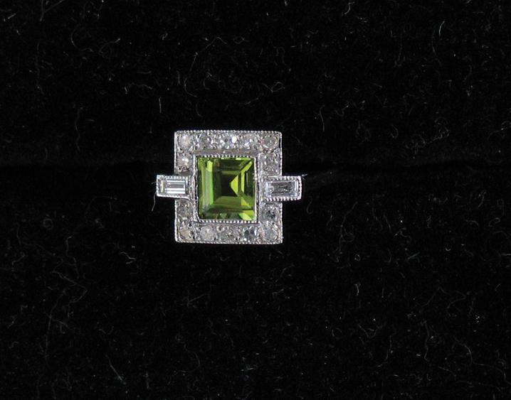 Appraisal: A PERIDOT AND DIAMOND DRESS RING the central step-cut peridot