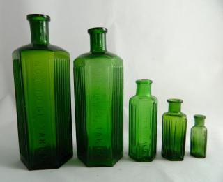 Appraisal: Poison green hexagonal bottles Poison- green hexagonal all embossed 'Not