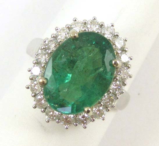 Appraisal: EMERALD DIAMOND AND FOURTEEN KARAT WHITE GOLD RING with round-cut