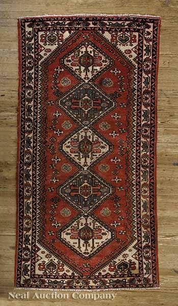 Appraisal: A Persian Carpet red and cream ground central diamond medallions