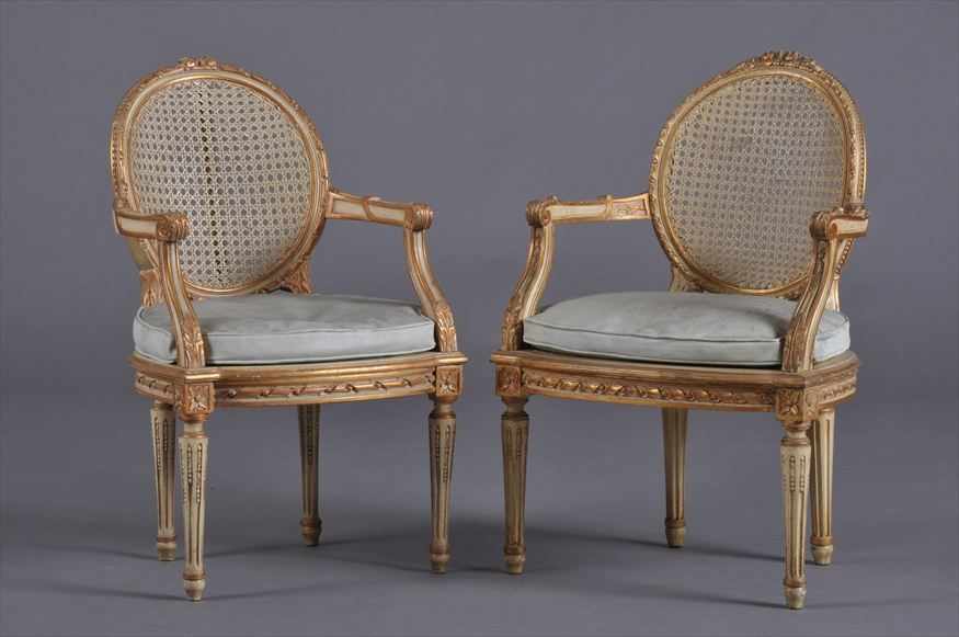 Appraisal: PAIR OF LOUIS XVI STYLE CARVED PAINTED AND PARCEL-GILT CHILD'S