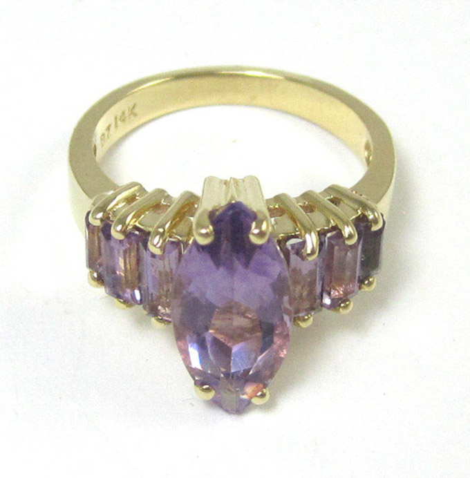 Appraisal: AMETHYST AND FOURTEEN KARAT GOLD RING with three baguette-cut amethysts