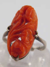 Appraisal: A white metal tests silver carved coral ring