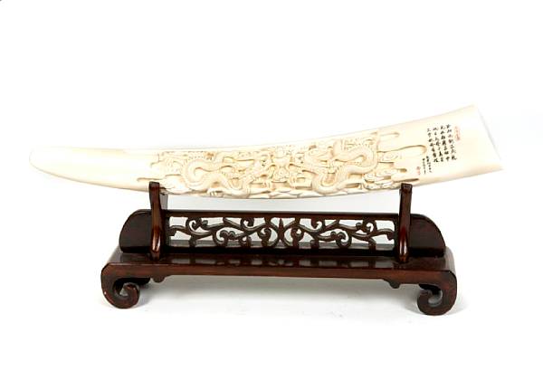 Appraisal: An ivory tusk with carved dragon decoration height in width