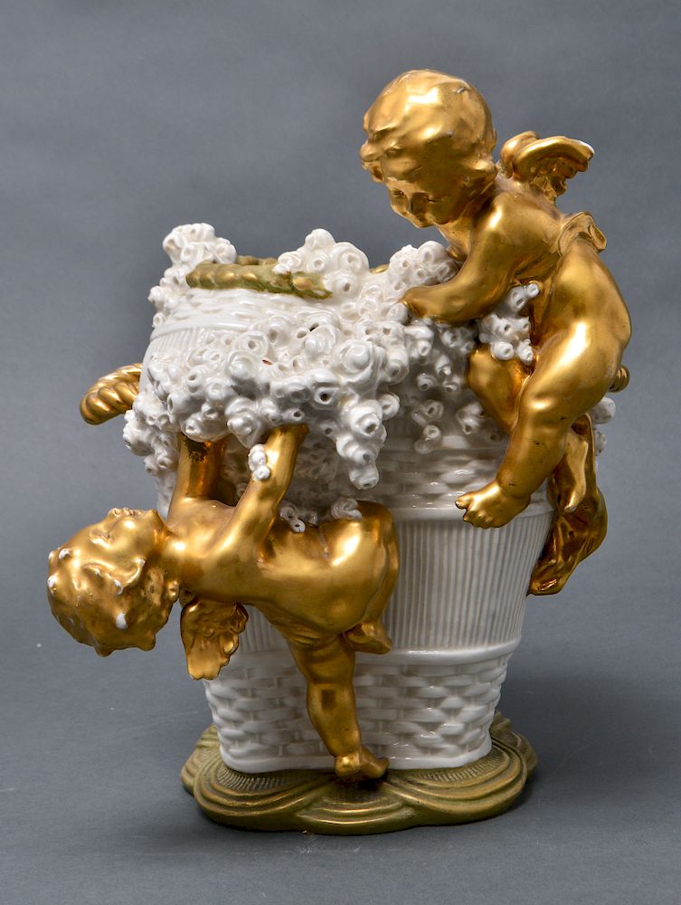 Appraisal: Amphora Pottery Basket Vase with Gilt Cherubs Amphora pottery basket