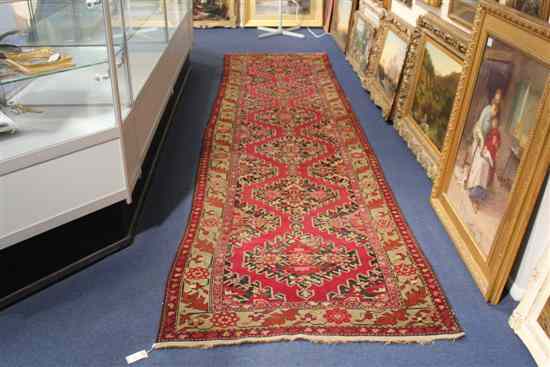 Appraisal: A Persian runner with six central embossed stepped diamond motifs