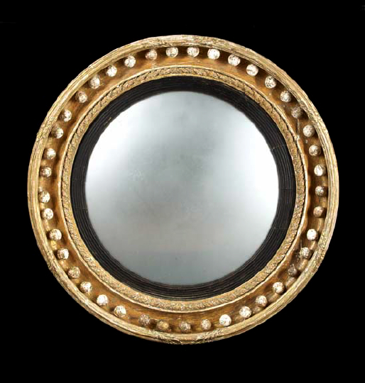 Appraisal: English Regency Carved Gilded and Parcel-Ebonized Convex Looking Glass first