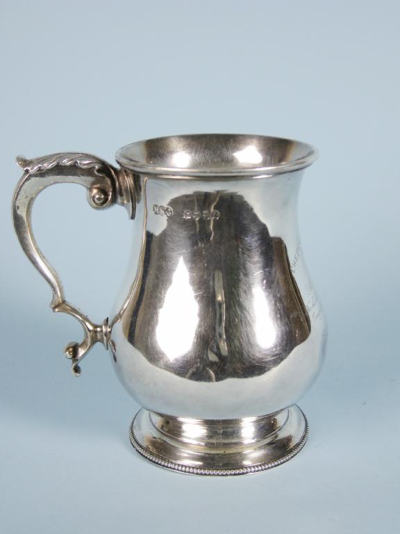 Appraisal: A Victorian baluster Pint Mug with leafage scroll handle beaded