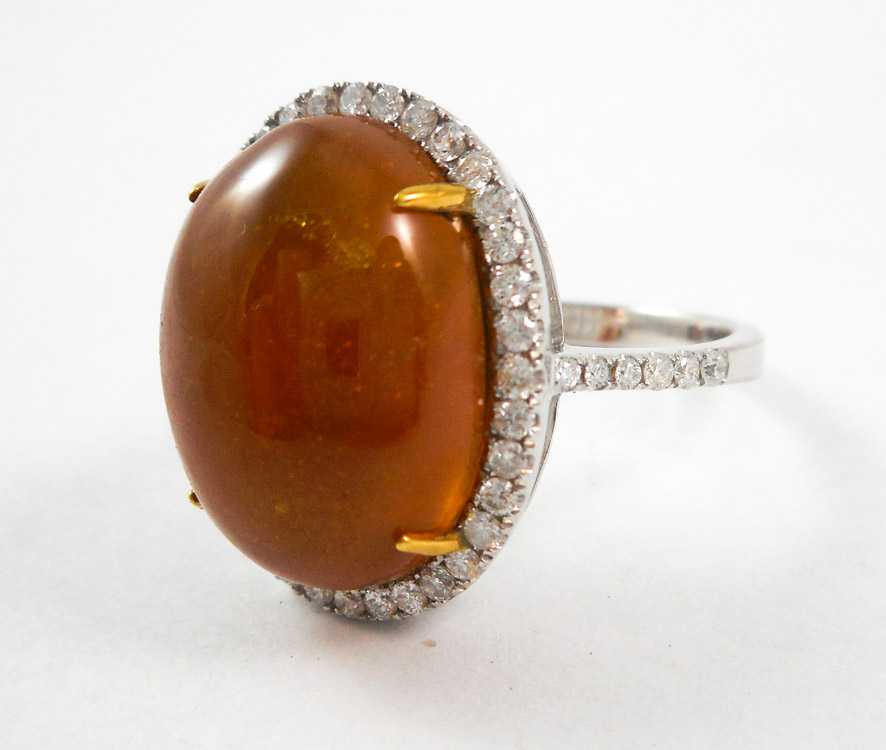 Appraisal: IMPERIAL TOPAZ AND FOURTEEN KARAT WHITE GOLD RING with round-cut