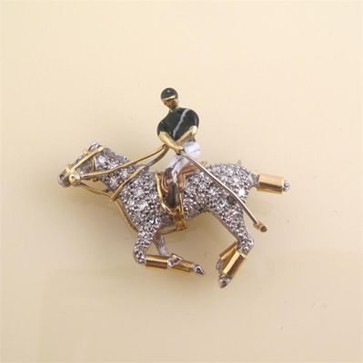 Appraisal: A gold diamond set polo player and pony brooch The