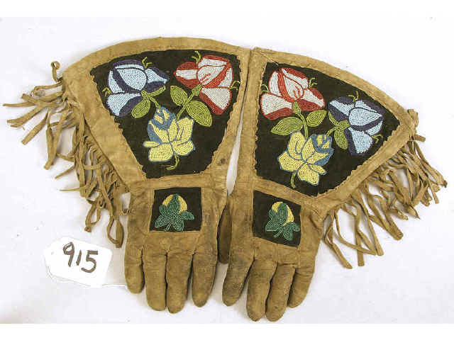 Appraisal: Pair of beaded rawhide friged gauntlets circa - machine sewn