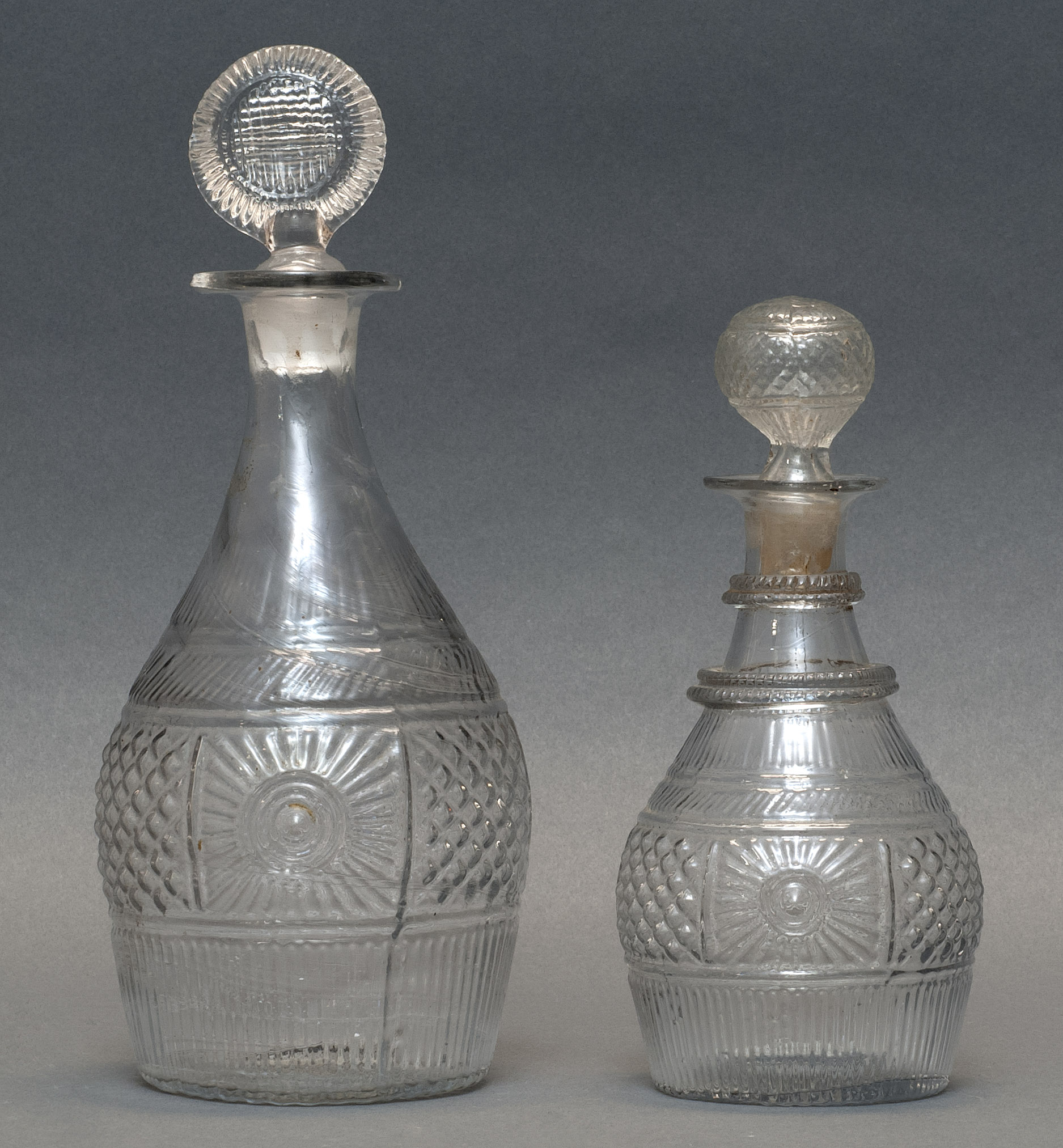 Appraisal: TWO CLEAR GLASS BLOWN -MOLD DECANTERS Second Quarter of the