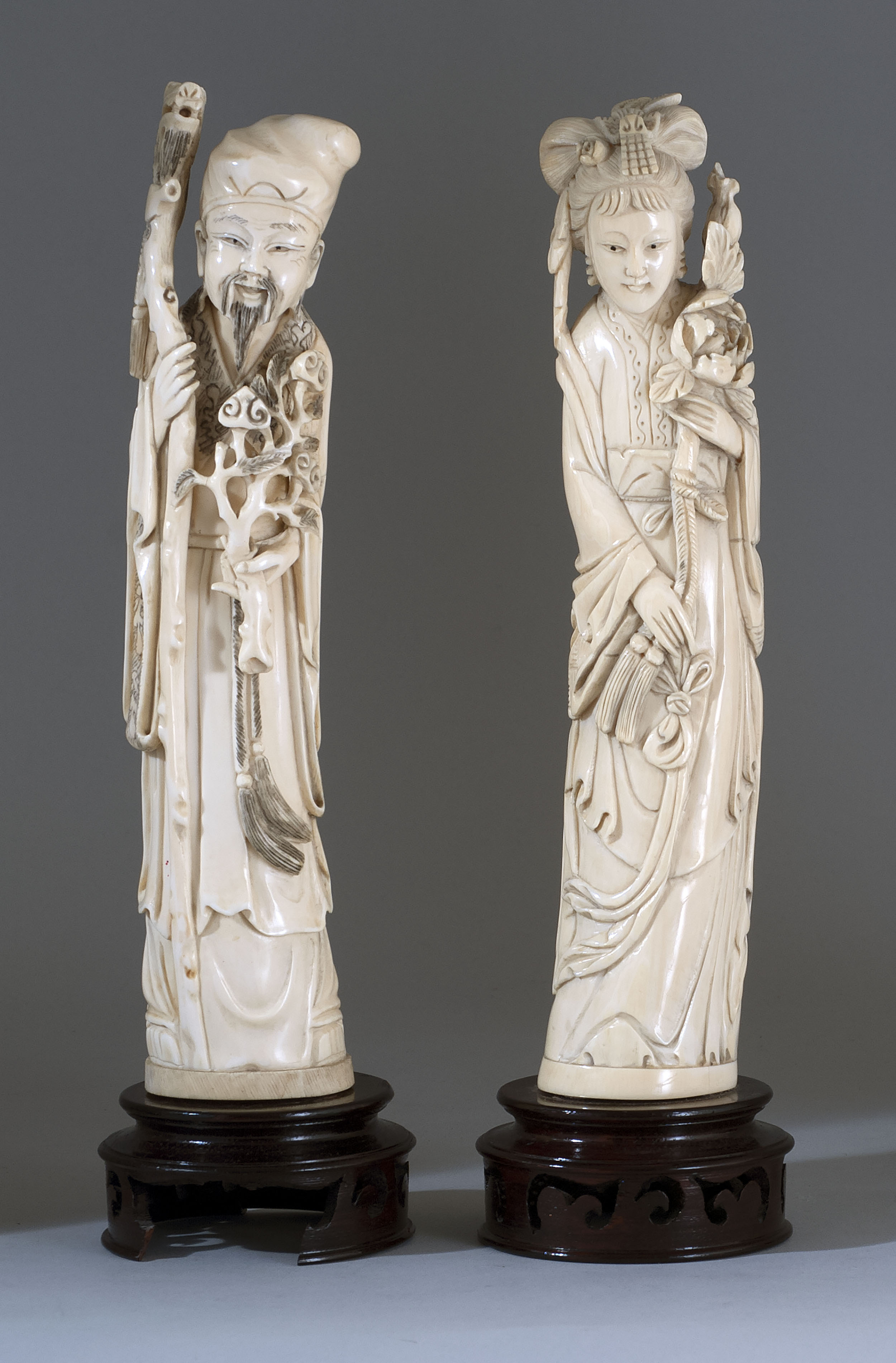 Appraisal: PAIR OF IVORY FIGURES Mid- th CenturyDepicting a sage with