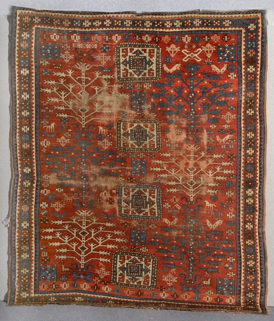 Appraisal: A CAUCASIAN KAZAK RUST GROUND RUG decorated four stylised central